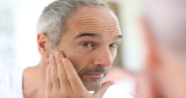 blog picture of older man looking at self in the mirror