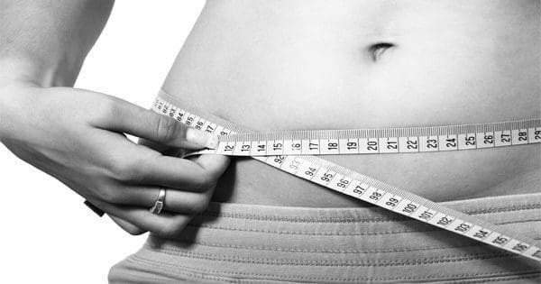 blog picture of woman measuring her belly