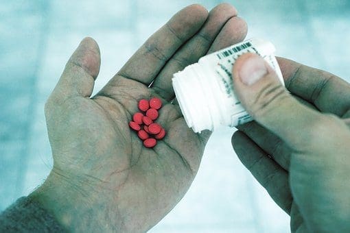 blog picture of open hand pouring some pills into it