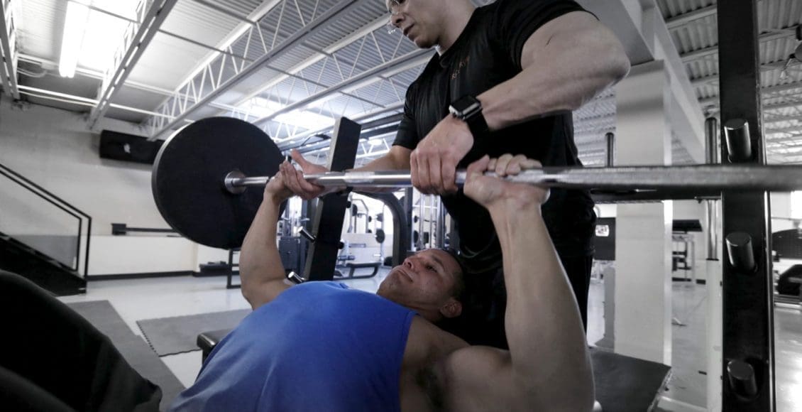 daniel doing bench press & dr. jimenez spots